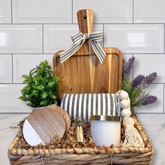 a wooden cutting board sitting on top of a table next to a basket filled with items