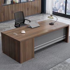 an office desk with a laptop on it in front of a large window overlooking the city