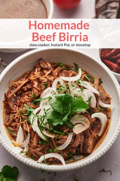 a white bowl filled with beef and onions on top of a table next to other food