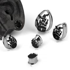 three different types of ear plugs with black and white designs on them, all in various sizes