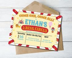 a circus themed birthday party card on top of an envelope