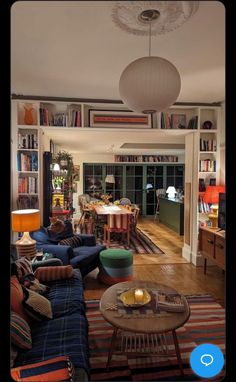 a living room filled with furniture and bookshelves