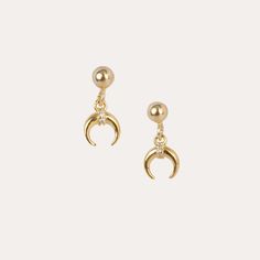 These gold crescent moon stud earrings are made with 14k gold-filled and great for everyday wear. They are set with cute stud earrings and a dangling crescent moon charm giving a minimalist look yet an edgy statement piece ! You may mix and match with other gold earrings to create your unique ear stack. 14K gold-filled ball stud earring 14K gold-plated crescent moon charm Ball Stud earring (size): 4mm x 4 mm Hypoallergenic Sold as a pair Earrings are non returnable due to hygiene reasons. Yellow Gold Moon Charm Drop Earrings, Celestial Crescent 14k Gold Earrings, Dainty Gold Earrings With Moon Phase, Yellow Gold-plated Moon Charm Earrings, Gold Plated Yellow Gold Earrings With Moon Charm, 14k Gold Crescent Moon Charm Earrings, Yellow Gold Plated Earrings With Moon Charm, Dainty Gold Crescent Cartilage Earrings, Celestial Crescent Earrings For Everyday