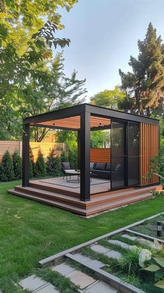 an outdoor living area in the middle of a yard with grass and trees around it