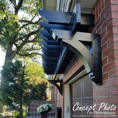 the front entrance to a brick building with an iron fence and flower potted planter