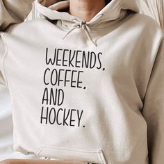 a woman wearing a sweatshirt with the words weekends coffee and hockey printed on it