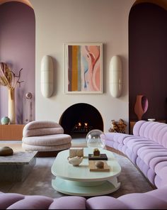 a living room filled with furniture and a fire place in the middle of the room