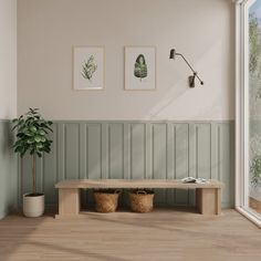 a wooden bench sitting next to a potted plant on top of a hard wood floor