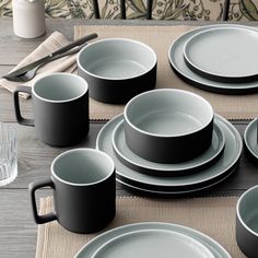 the table is set with black and white dishes