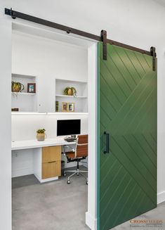 an open door leading to a desk with a computer on it in a home office