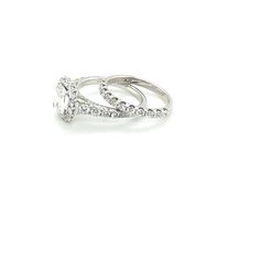 a white gold and diamond ring on a white background