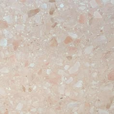 a close up view of a marble floor with pink and white speckles on it