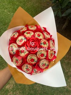 a bouquet of red and gold flowers in someone's hand with the words 16 international bouquets on it