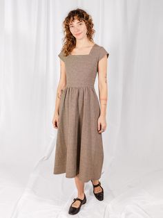 This fit and flare midi dress is back in a timeless houndstooth. Featuring a flattering square neckline, cap sleeves, and hidden pockets, Rupi brings a more tailored and structured look with bust darts, a zip-up back, and fitted waist. Fit Note: Fitted style. Those in between sizes may wish to size up. 100% cotton Woven check Hidden pockets Zips at back Length of size M is 46.5" from top of bodice Made fair trade in Nepal by one of our longstanding production partners Fit And Flare Midi Dress, Flare Midi Dress, Fair Trade Clothing, Dress Home, Thrift Shopping, Black Maxi, Black Wrap Dress, Maxi Wrap Dress, Black Rib