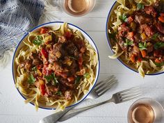 two bowls of pasta with meat and vegetables