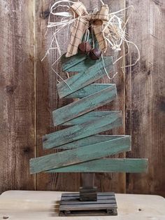 a christmas tree made out of wooden planks and tied with burlock on top