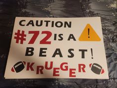 a sign that says caution 72 is a beast, kruger and football on it