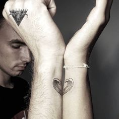 two people with matching tattoos on their arms