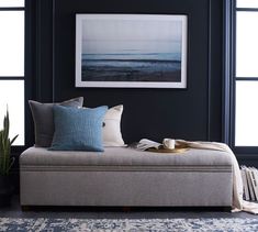 a living room with a couch, coffee table and potted plant