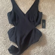 Cute And Sexy Body Suit. Never Worn And New With Tags! Super Cute For Going Out And Great With Jeans! Black Lined Tops For Night Out, Black Cutout Top For Evening, Fitted Low-cut Bodysuit, Black Cutout Evening Tops, Low-cut Lined Bodysuit, Fitted Black Bodysuit With Cutout, Fitted One-piece Bodysuit With Cutout, Fitted V-neck Cutout Bodysuit, Body Suit