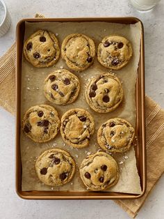 chocolate chip cookies on a baking sheet with icing and sprinkles, ready to be eaten