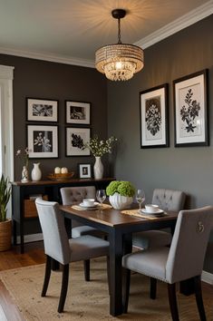 a dining room table with chairs and pictures on the wall