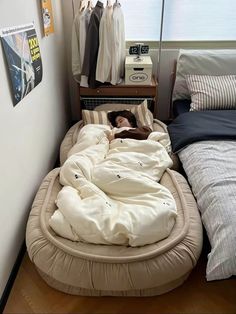 a woman is sleeping in a bed made out of an animal shaped mattress and pillows