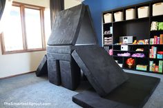 an indoor play area with black foam blocks