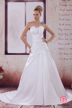 a woman in a white wedding dress posing for the camera