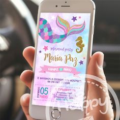 a person holding an iphone with a mermaid party ticket on the screen in their hand