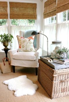 a living room filled with furniture and lots of pillows on top of a rug next to a window