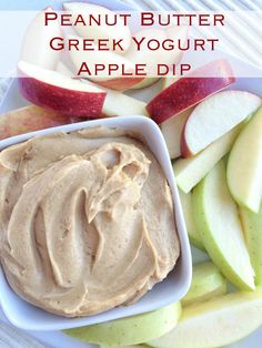 an apple and peanut butter greek yogurt dip on a plate with sliced apples