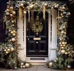 a door decorated with christmas ornaments and greenery