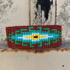 Beaded Wristband Bracelet, Handcrafted, Casual Bracelets, Loom, Jewelry, Multicolored Seed Beads, Teal and Brown, Western Look, 1 x 7 inch Sparkly seed beads where used to create this beautiful beaded bracelet. *Casual Wear Beaded Bracelet *Native American Inspired Design *The bracelet can be secured at one of three lengths with a beaded button. *Handmade in Guatemala Brown Beaded Friendship Bracelets With Round Beads, Brown Bracelets With Large Beads For Festival, Brown Beaded Friendship Bracelets, Traditional Handmade Brown Stretch Bracelet, Adjustable Brown Beads For Crafting, Southwestern Style Bracelets With Large Beads As Gift, Southwestern Style Beaded Bracelets Gift, Southwestern Green Beaded Bracelets With Round Beads, Brown Tiny Beads Bracelets For Festival