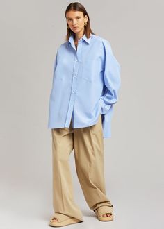 Color: White/Light Blue Lightweight shirting fabric Oversized fit Pointed collar Single breast pocket High-low curved hem Button front closure 100% Cotton Dry Clean By The Frankie Shop. Imported Product Measurements: XS/S - 24" Shoulder, 56" Bust, 31" Length M/L - 25" Shoulder, 59" Bust, 31.5" Length Model is 174cm/ 5'8" wearing size M/L Blue And White Striped Shirt Outfit, White Striped Shirt Outfit, Blue And White Striped Shirt, Denim Projects, Shirting Fabric, The Frankie Shop, Frankie Shop, Top Design Fashion, Stripe Shirt