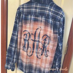 an old flannel shirt with the word buffalo on it is hanging in a doorway