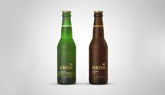 two bottles of kron are shown side by side on a white background, one is green and the other is brown