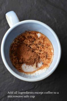 an overhead view of a cup of coffee with cocoa powder in it and the words add all ingredients except coffee to a microwave safe cup