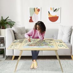 a woman sitting at a table with a map on it