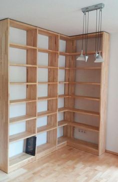 an empty room with wooden shelves and lamps