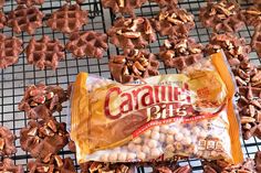 a bag of caramel bits sitting on top of a cooling rack filled with nuts