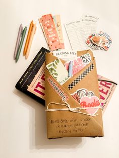 a bunch of different types of papers and pens on top of a white countertop