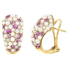 Earring (Matching Ring Available) Yellow Gold 18K Weight 10.15 grams Diamond 14-Bril.Cut-0.53 ct G/SI1A Mother of Pearl 66-3.09 ct Pink Sapphire 30-1.57 ct Uncover the elegance of structural beauty with this striking ring, masterfully crafted from6.05 grams of 18k yellow gold. At the heart of this design lies a stunning 7.63-carat beryl, radiating a serene hue that captures the essence of contemporary luxury. Complementing this magnificent centerpiece is a 3.62-carat tanzanite, known for its enthralling deep blue- violet sparkle. This ring, size 54, seamlessly merges the art of architecture with the allure  of fine gemstones, creating a piece that is both a statement and a sculpture. With a heritage of ancient fine Swiss jewelry traditions, NATKINA is a Geneva based jewellery brand, which Yellow Gold Earrings, Bleu Violet, Matching Ring, Contemporary Luxury, Matching Rings, Blue Violet, Yellow Gold Earring, Pearl Diamond, Mother Pearl