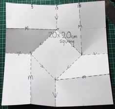 the paper is cut into squares to make an origami style pattern for this quilt