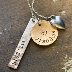 "New grandma personalized gift. Show your grandparent pride with this \"established\" grandma necklace. 1 1/4\" handstamped silver tag in script font \"est.\" with date you became (or will become) a grandma. Has a brushed satin, hammered finish. Charm is silver alkeme', which is a metal alloy that won't tarnish and is very durable. It is hypo-allergenic and nickel free and made in the USA. 5/8\" brass disc stamped \"grandma\" or any name you prefer... nana, mama, granny, etc. 1/4\" silver heart Engraved Name Necklace For Anniversary On Mother's Day, Engraved Name Necklace For Mother's Day Anniversary, Silver Name Necklace For Father's Day Anniversary, Hand Stamped Necklaces For Anniversary On Mother's Day, Hand Stamped Nameplate Necklace For Anniversary, Mother's Day Engraved Name Necklace For Anniversary, Engraved Adjustable Name Necklace For Anniversary, Hand Stamped Nameplate Jewelry For Anniversary, Hand Stamped Nameplate Jewelry For Anniversary Gift