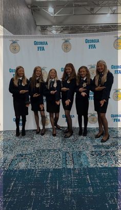 five women standing in front of a backdrop with the words georgia fea on it