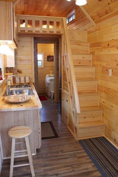 a kitchen and stairs in a tiny cabin