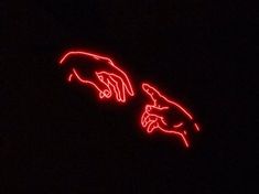 the creation of two hands in red neon light on a black background is seen from below