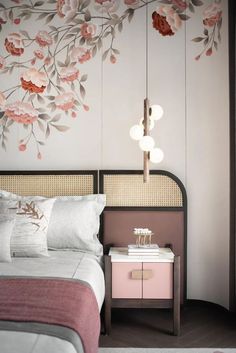 a bed room with a neatly made bed and flowers on the wall