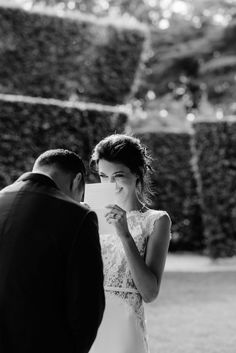 the bride and groom are looking at each other